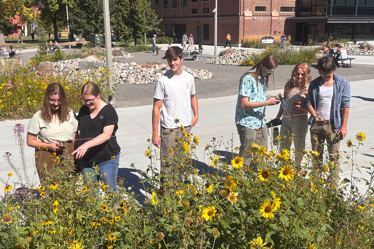 university students record data on campus plants